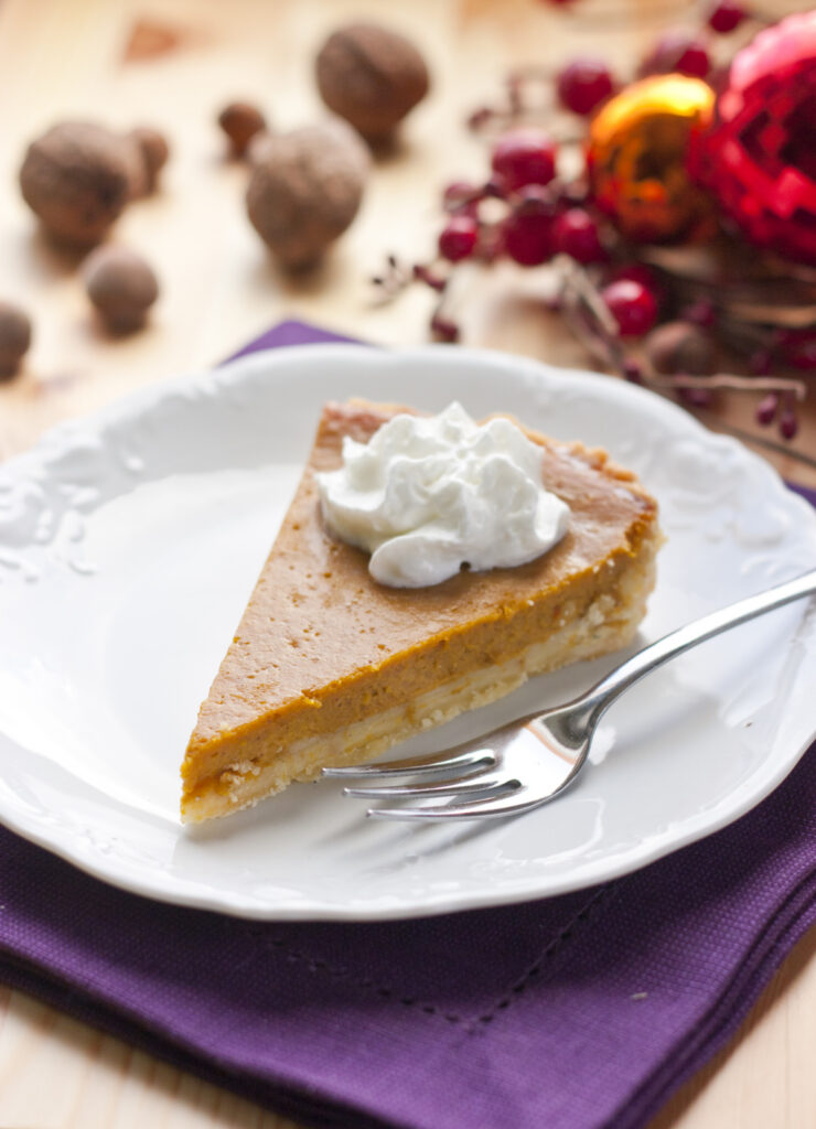 Slice of pumpkin pie with whipped cream