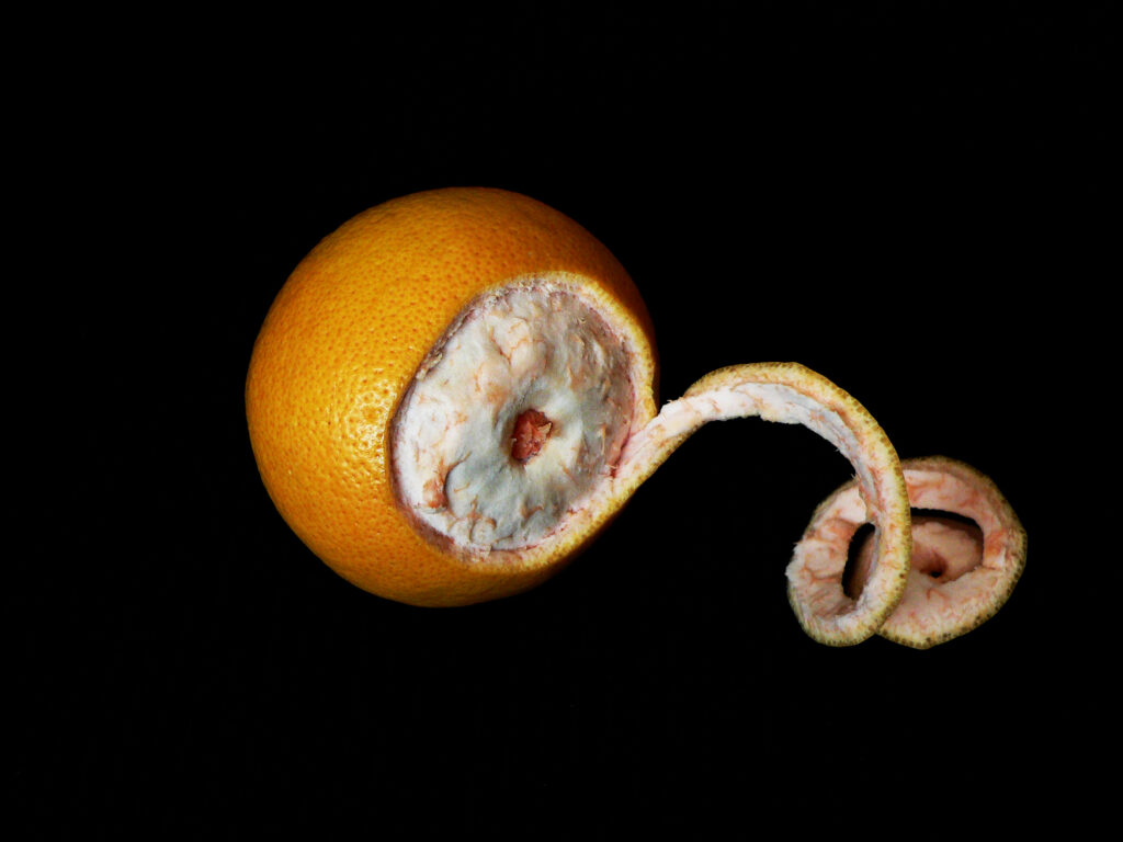Orange with its peel partially removed in a spiral