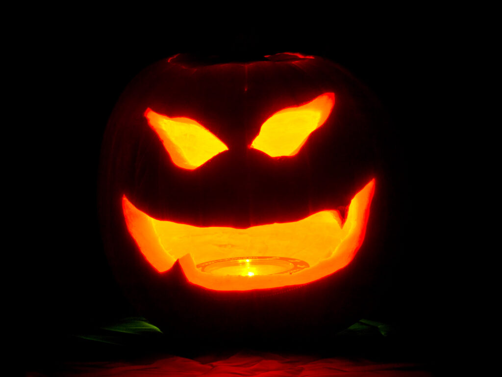Carved jack-o-lantern glowing in the dark