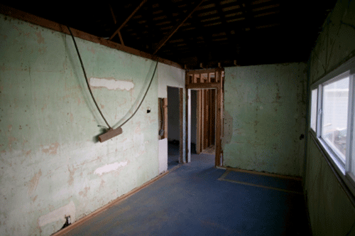 Gutted basement with drywall removed during remediation